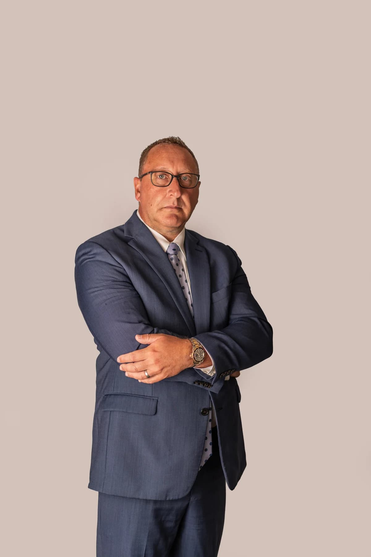 Chad Delventhal, Fort Wayne injury attorney, with arms crossed in a navy suit